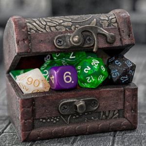 DUNGEONS AND DRAGONS Club shows a toy treasure chest with Tetrahedron dice
