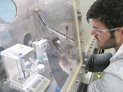 Health Sciences student at vent hood conducting a lab procedure