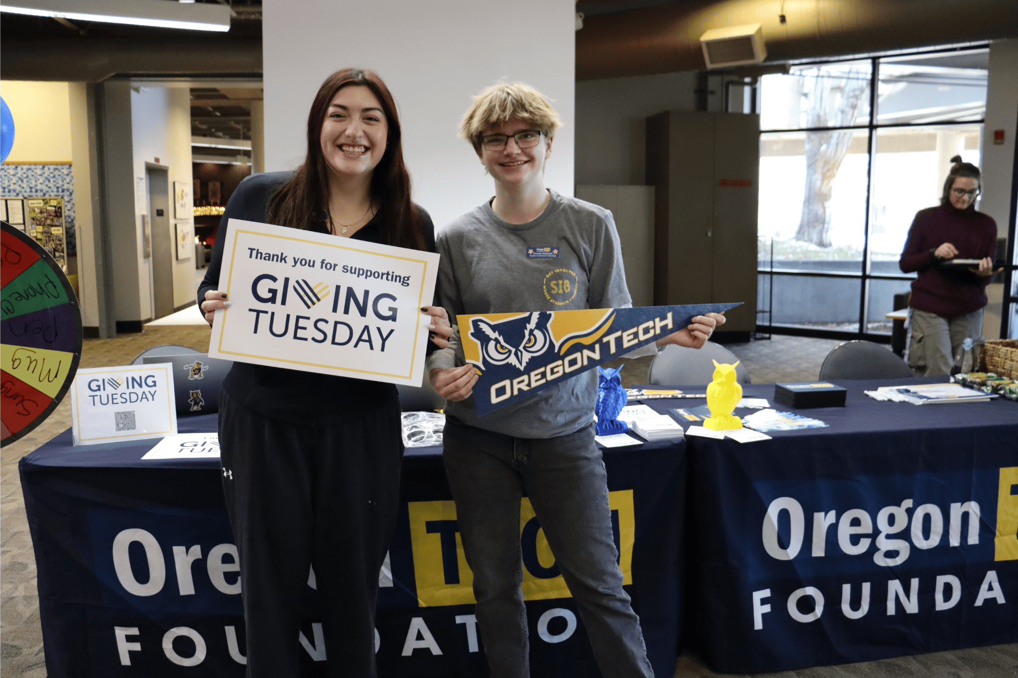 Students holding signs on Giving Tuesday