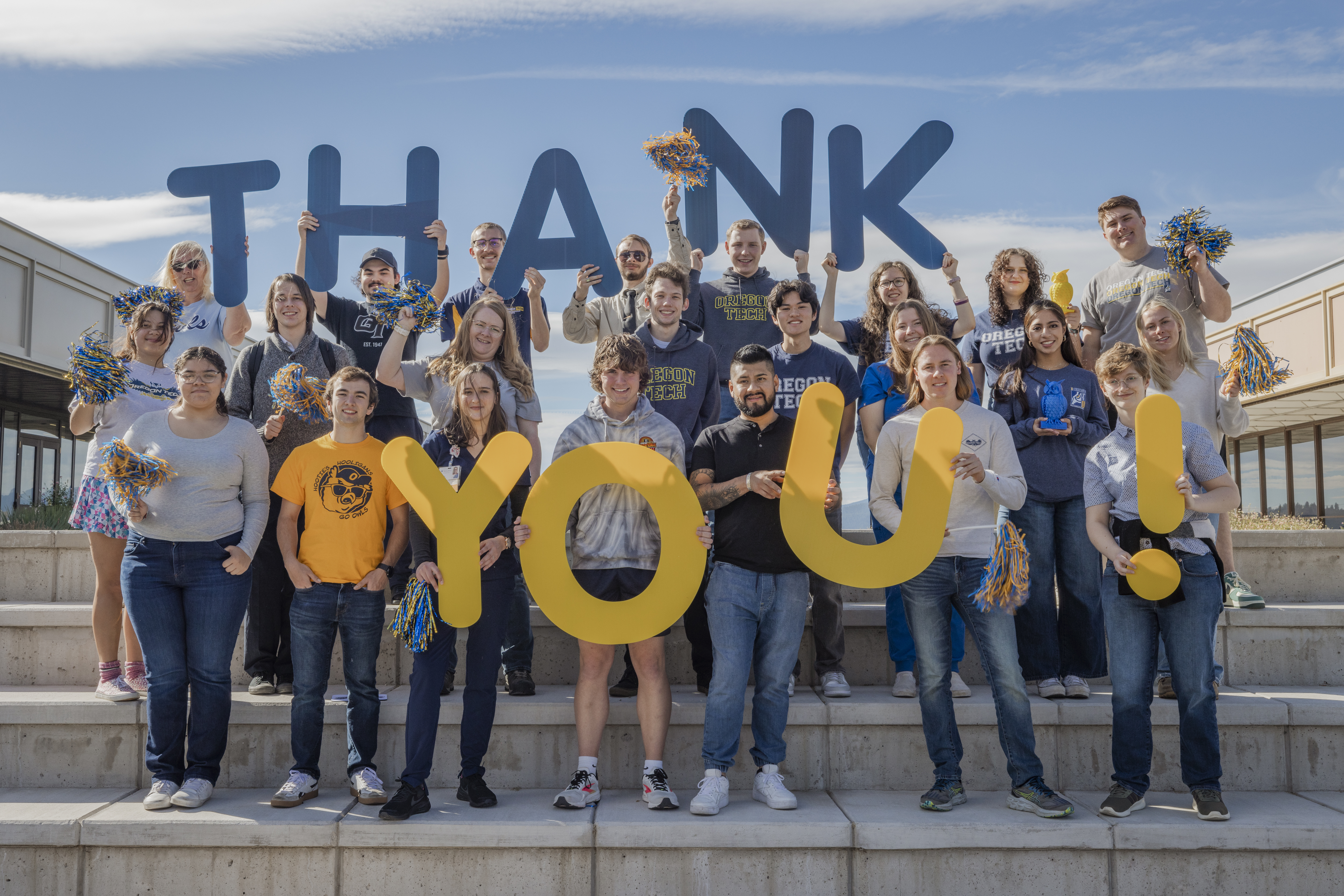 Students holding a thank you sign