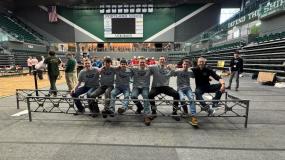 Steel Bridge team and Faculty Advisor sitting on the steel bridge