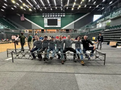 Steel Bridge team and Faculty Advisor sitting on the steel bridge