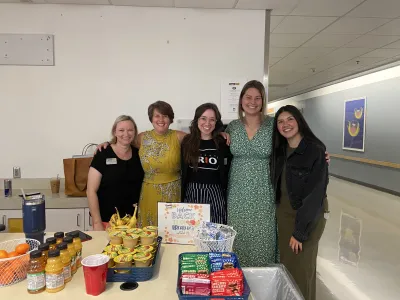 Student Affairs staff members serve treats to welcome students in fall 2024. 