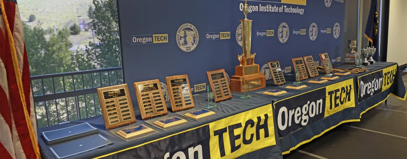 Table display of Student and Alumni Awards plaques and trophies