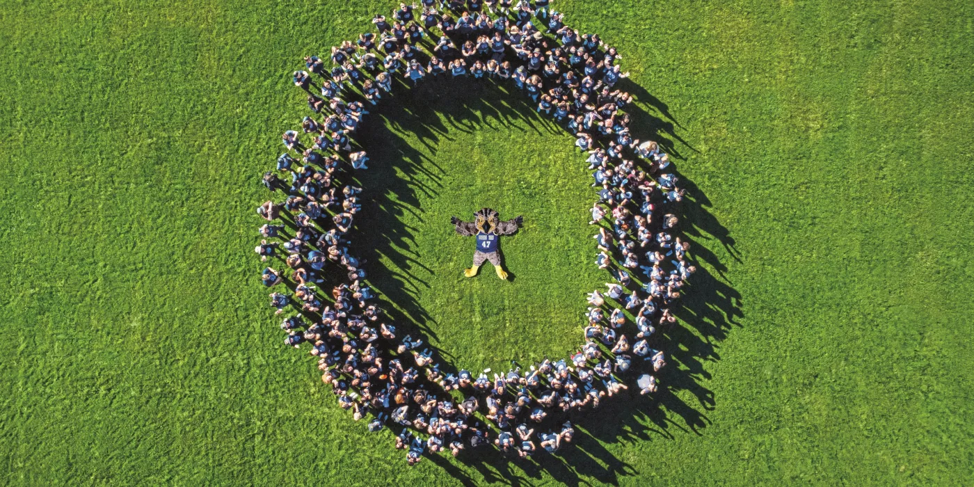 New Hootie in circle of students