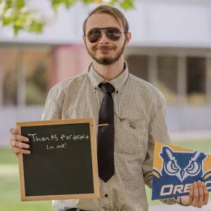 Student holding sign