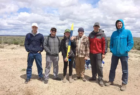 Rowan & Oregon Tech rocketry club students preparing to launch a rocket that they built