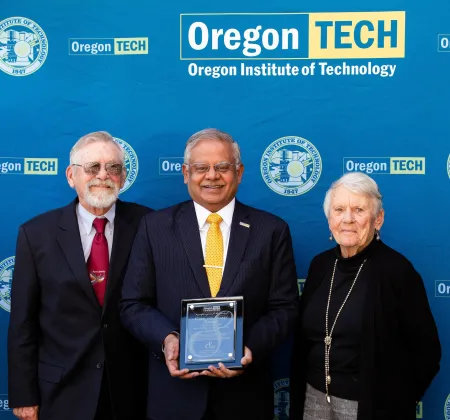 President Naganathan presenting appreciation plaque to Glen and Sherry Thomet