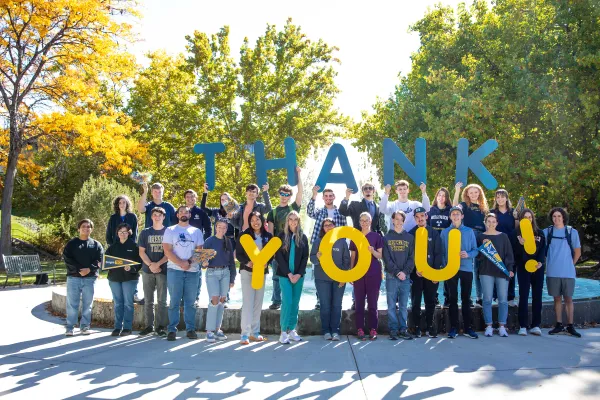 Students holding up a thank you sign