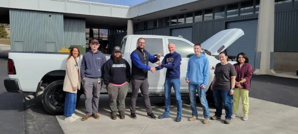 General Sales Manager Brandon Berg handing keys to Civil Engineering Professor Dr. Roger Lindgren